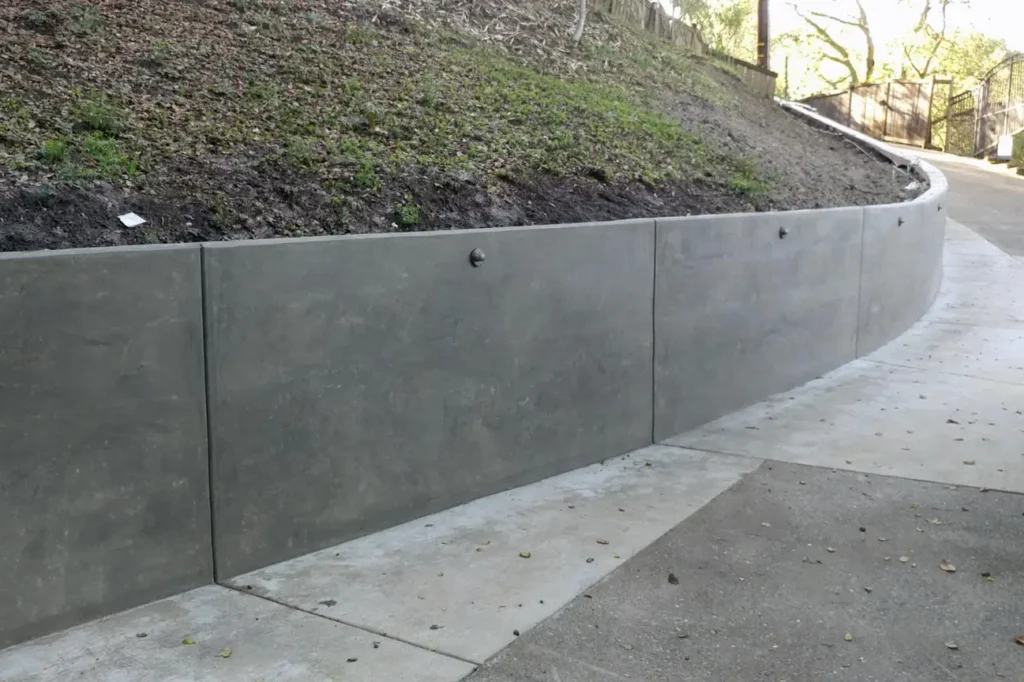 Concrete Retaining Walls Christchurch building a curved concrete retaining wall for improved land stability on sloped ground