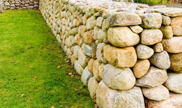 Stone Walls Christchurch natural boulder retaining wall showing strong stone walls services Christchurch craftsmanship