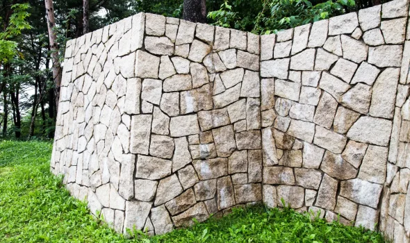 Stone Walls Christchurch long stone retaining wall designed for wide outdoor areas and stone walls services Christchurch projects